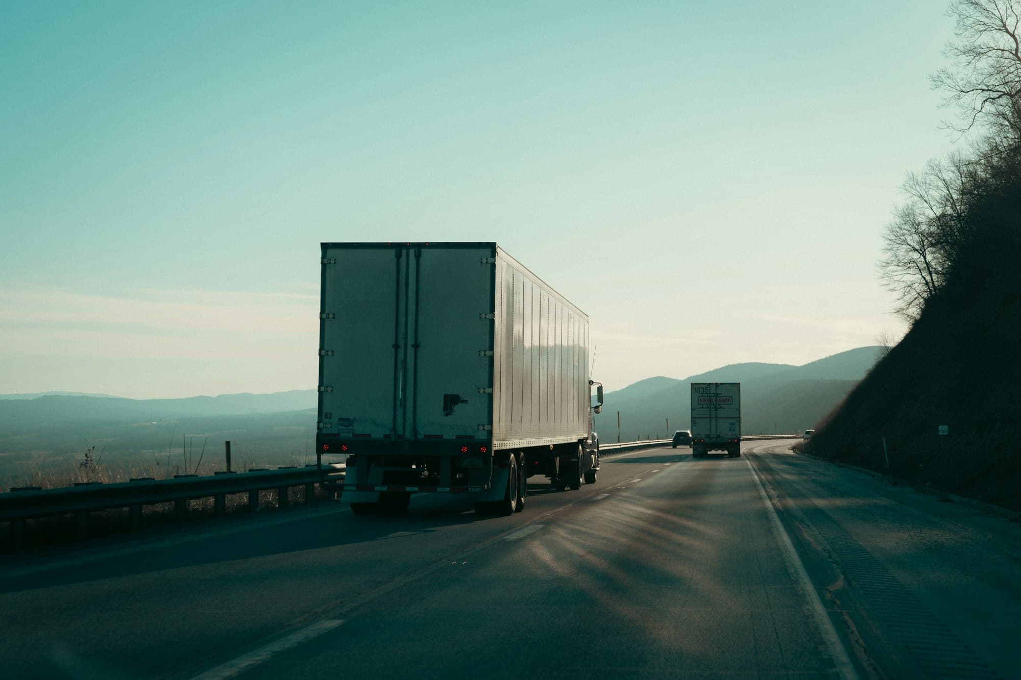 Freight trucks travelling along a mountain highway